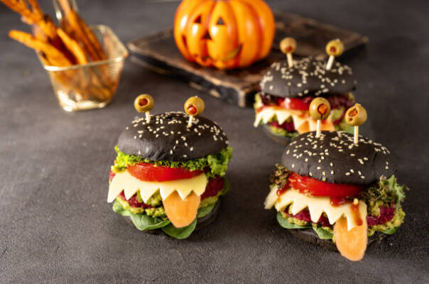 Burgers monsters for Halloween celebration on grey background. Copy space
